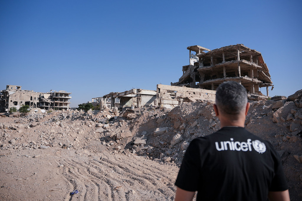 Many towns and cities suffered extensive damage during the Syrian civil war. Pictured here, UNICEF goodwill ambassador and Syrian actor Qays Sheikh Najib stands amid rubble and debris in Rural Damascus.